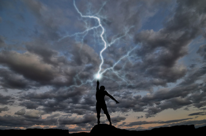 Lightning strikes the upraised hand of a man. 