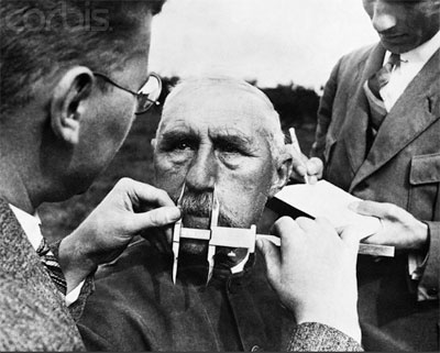 German man has his nose measured. 