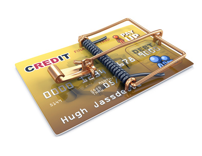 A credit card with a mouse trap attached.