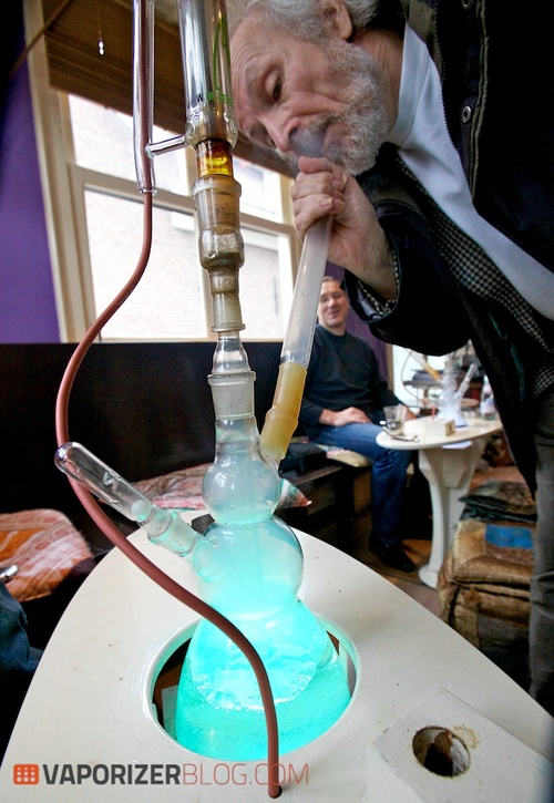 Using a vaporiser to vape cannabis.