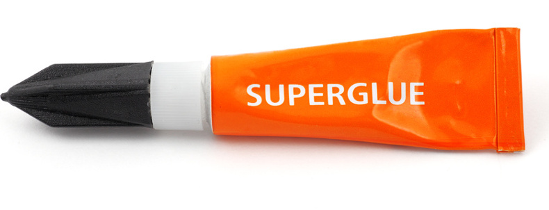 Orange plastic tube labeled superglue on white.