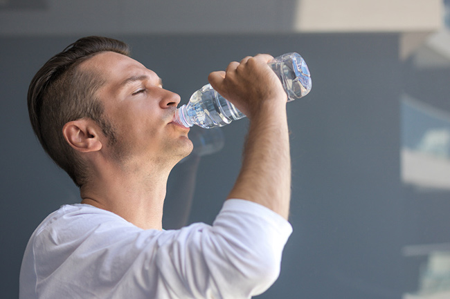 Man drinking a bottle of water