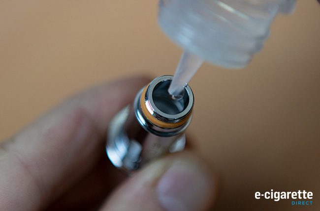 Dripping e-liquid into a coil to prime it