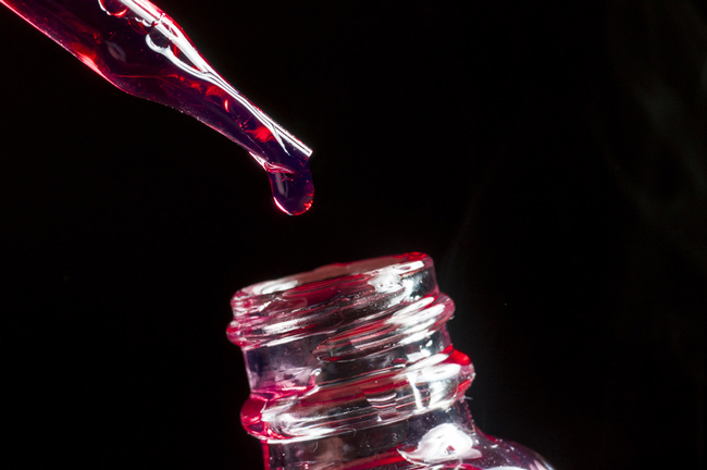 Pipette dripping e-liquid into a bottle