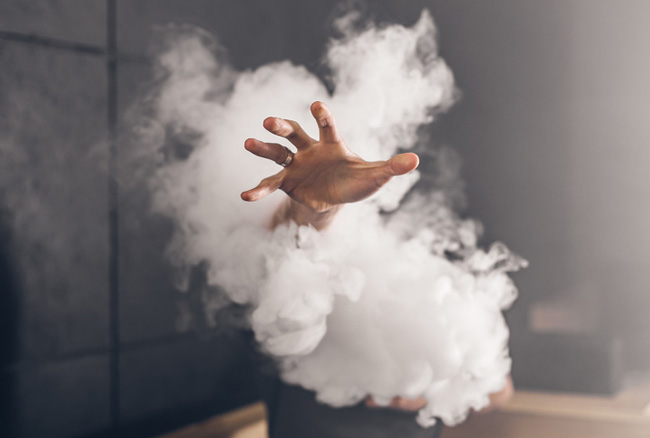 A hand reaching out of a large vapour cloud