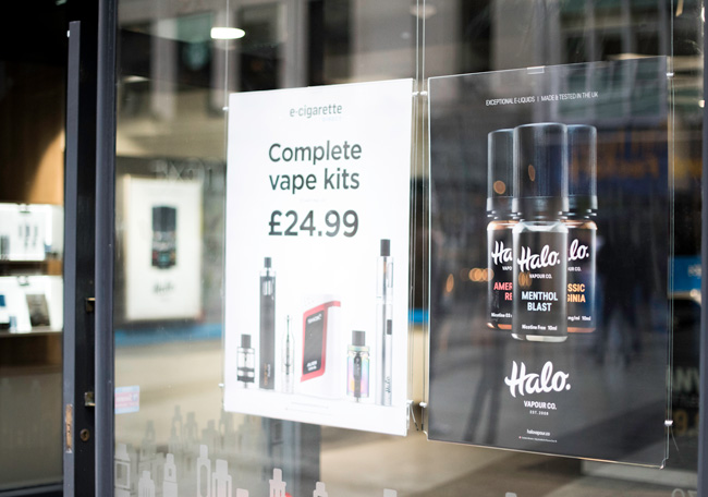 Posters in a vape show window. 