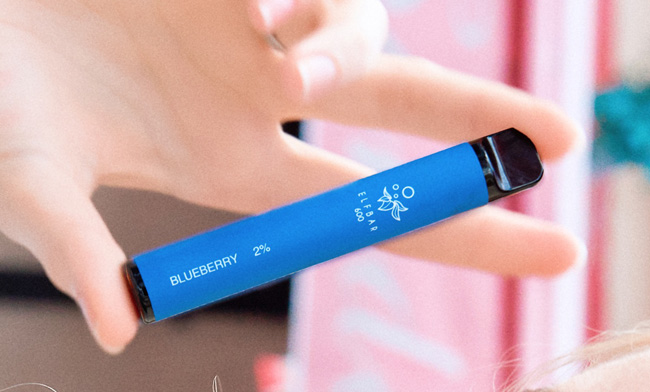 Image of a hand holding a blue-coloured, Blueberry Elf Bar disposable vape device